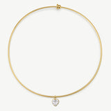 A delicate gold wire bangle necklace with a small heart-shaped clear gemstone pendant, displayed on a clean white background.