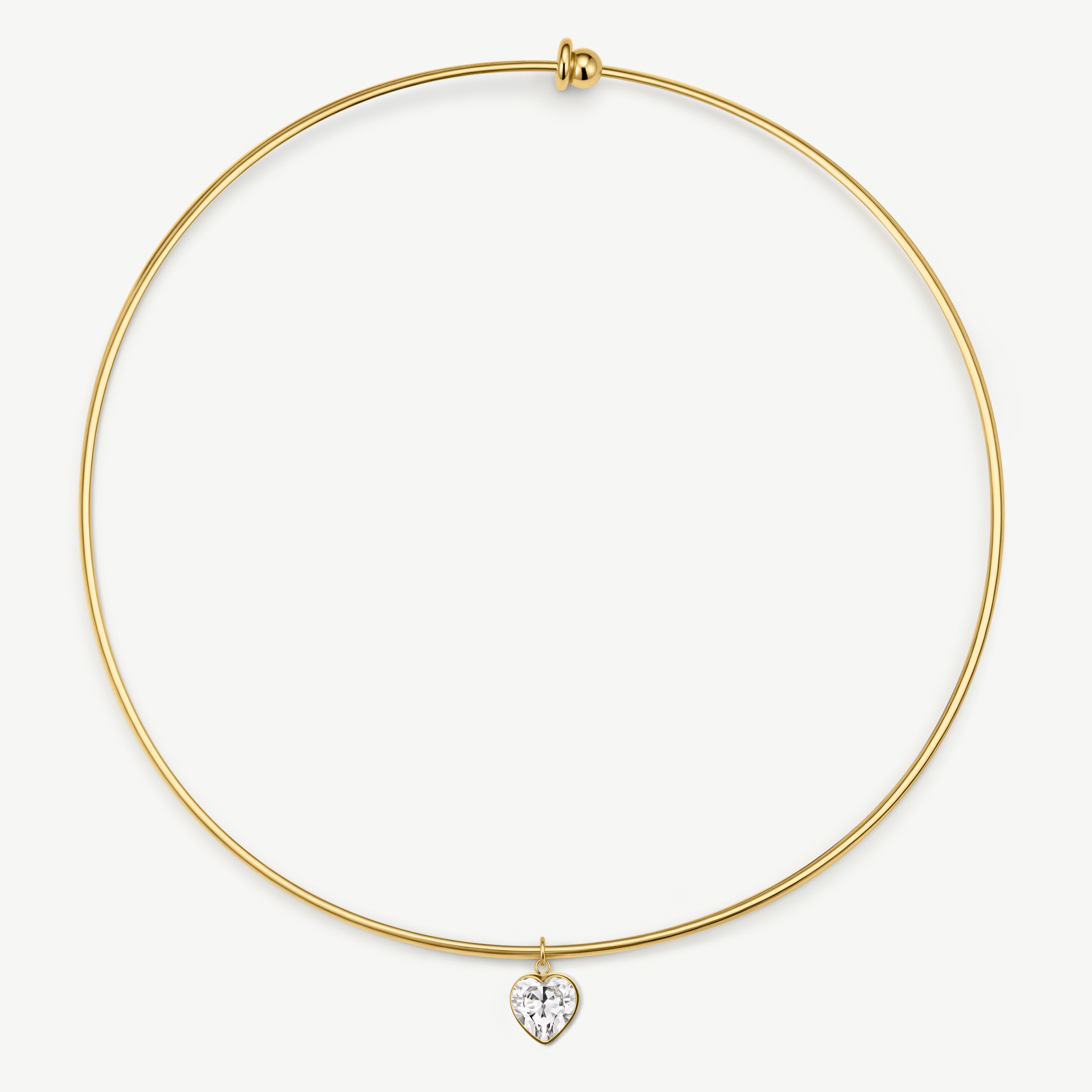 A delicate gold wire bangle necklace with a small heart-shaped clear gemstone pendant, displayed on a clean white background.