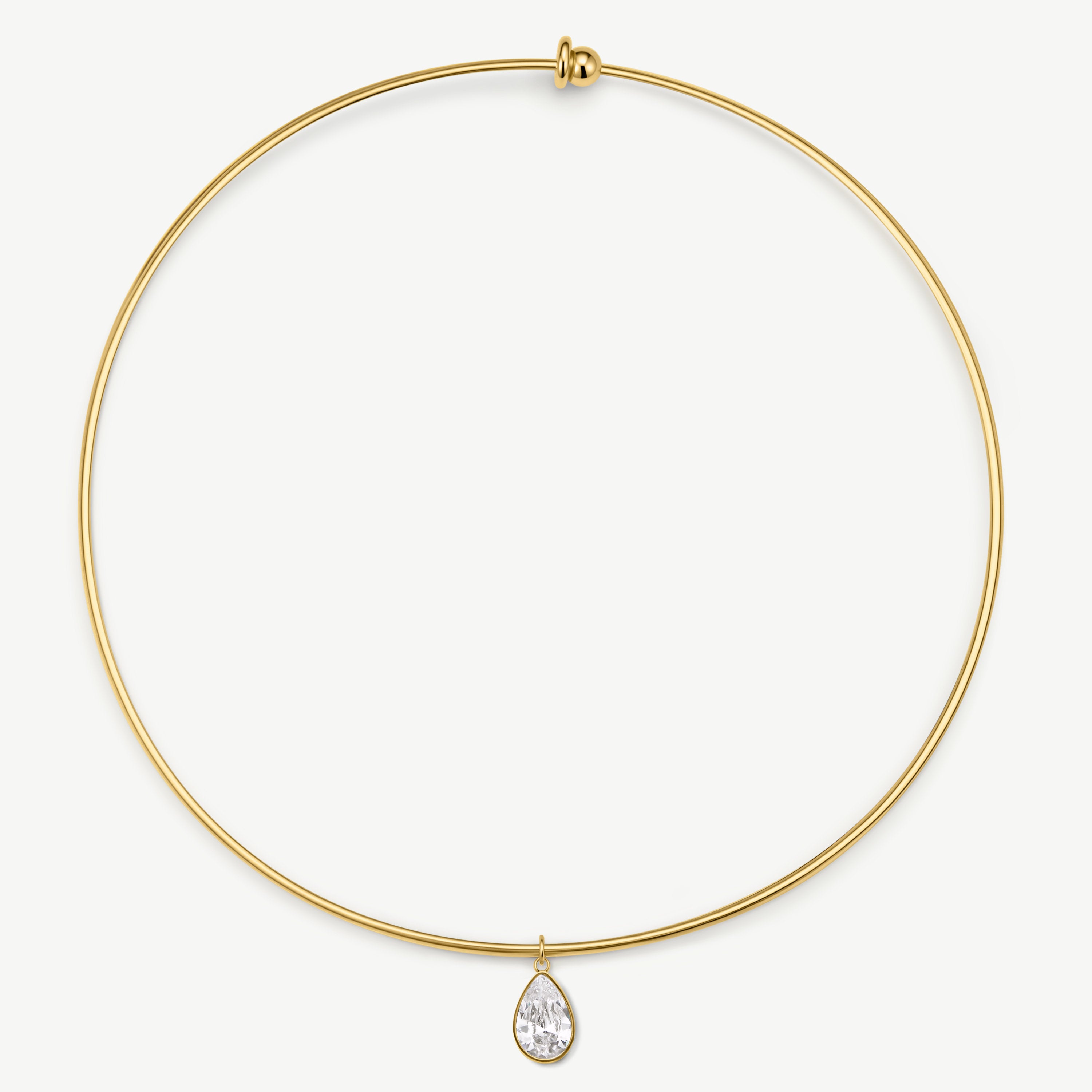 A delicate gold wire necklace with a small teardrop-shaped clear gemstone pendant, displayed against a clean white background.
