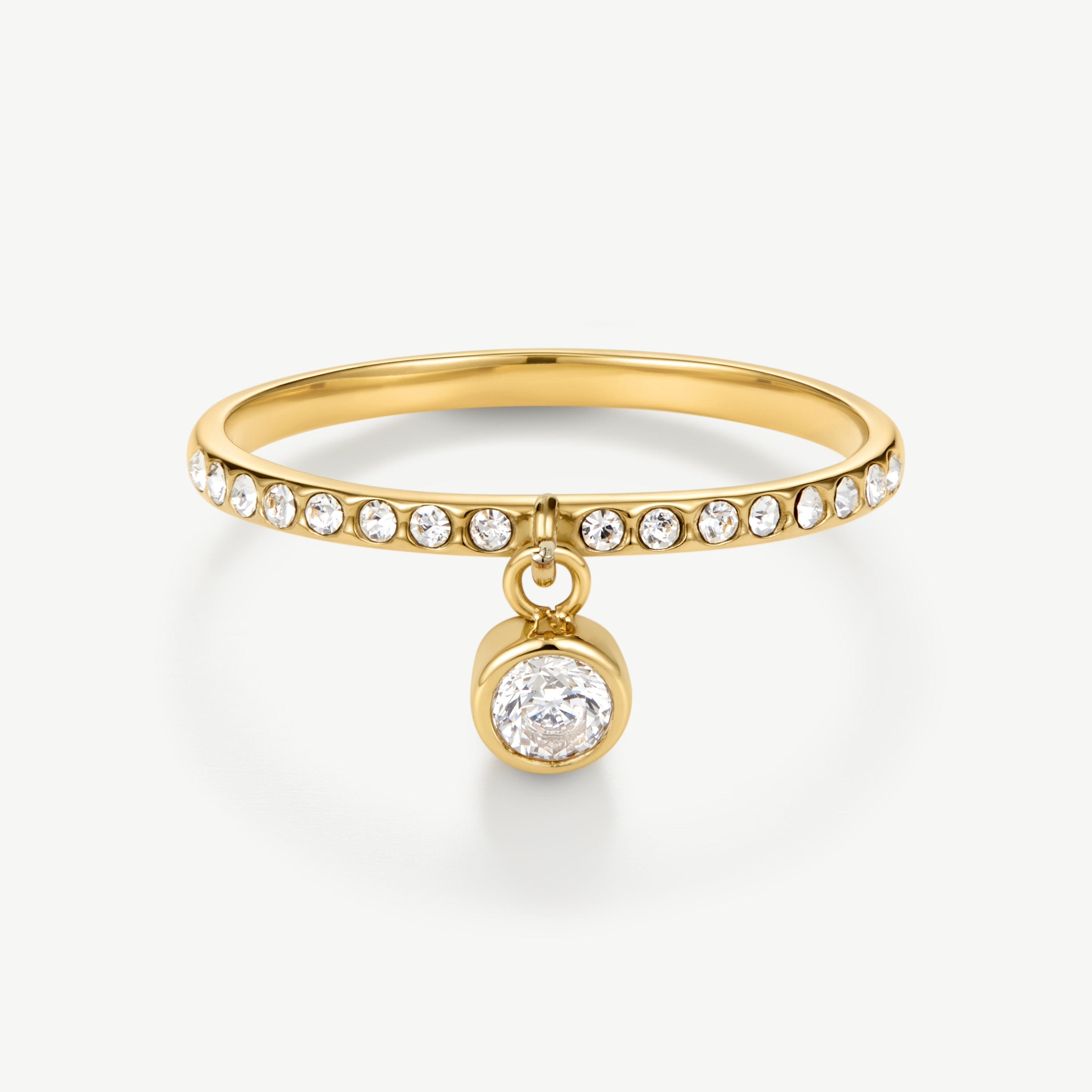 A gold ring featuring a thin band paved with small clear round stones and a dangling bezel-set round clear gemstone, shown on a clean white background.